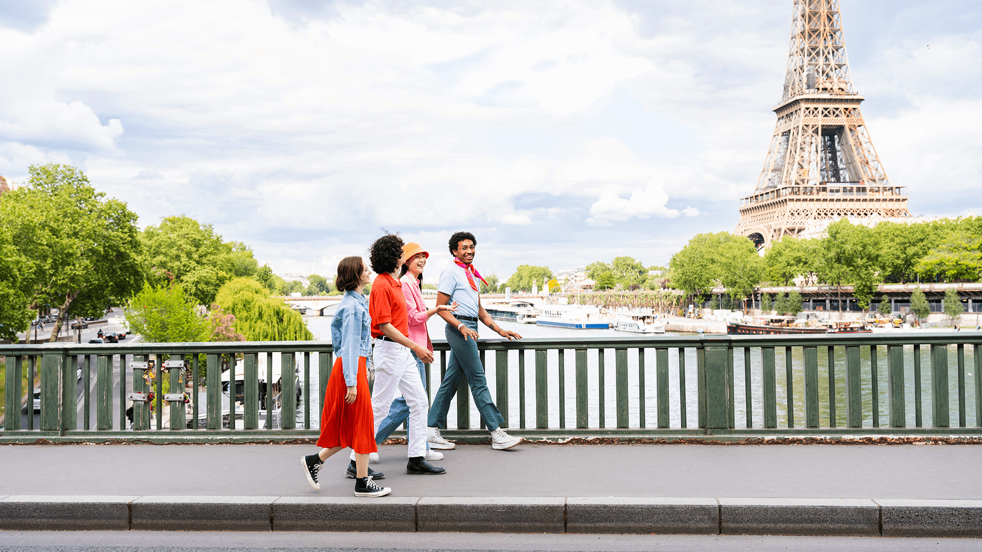 Photo of group of students walking through Paris, next to the Eiffel Tower